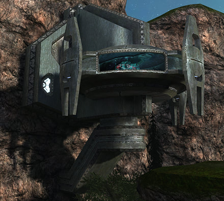 The UFO-like structure embedded in a cliff wall that contains the island's security station, a hologram just visible through a glass window.