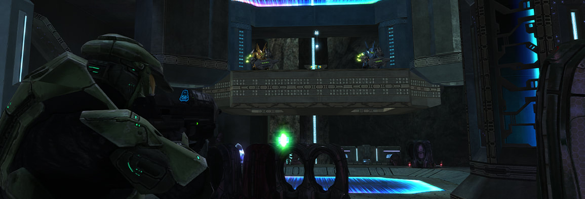 The Master chief aims his rifle at a Hunter pair approaching him on a large elevator.
