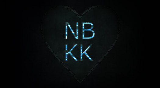 A metal heart embedded in a wall, etched with glowing blue letters NB KK.
